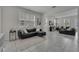 Bright, open-concept living room with tile flooring, two sofas, and large windows at 2916 Satire St, Kissimmee, FL 34746