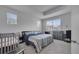 Spacious main bedroom boasts gray carpet, large windows, a crib, and a dresser at 2916 Satire St, Kissimmee, FL 34746