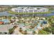 Aerial view of a lazy river with palm trees, waterways, and sunbathing area at 2916 Satire St, Kissimmee, FL 34746