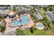Aerial view of resort-style pool area with ample seating, palm trees, and covered lounge at 2916 Satire St, Kissimmee, FL 34746