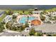 Aerial view of the community pool with palm trees, lounge chairs, and a tiki bar at 2916 Satire St, Kissimmee, FL 34746