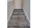 Carpeted stairs with white risers lead to the upper level of the home at 2916 Satire St, Kissimmee, FL 34746