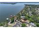 Aerial view showcasing waterfront property and lush surrounding landscape at 2929 Lakeshore Dr, Mount Dora, FL 32757