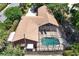 Aerial view of home with screened pool, set amidst lush landscaping at 2929 Lakeshore Dr, Mount Dora, FL 32757