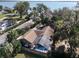 Aerial view of a property featuring a screened-in pool and views of a picturesque lake at 2929 Lakeshore Dr, Mount Dora, FL 32757