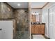Bathroom featuring a stone shower, dark fixtures, vanity and a white door at 2929 Lakeshore Dr, Mount Dora, FL 32757