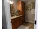 Bathroom with granite countertops, wood cabinets, and decorative wall art at 2929 Lakeshore Dr, Mount Dora, FL 32757