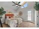 Inviting bedroom features a ceiling fan, neutral walls, and door to backyard area at 2929 Lakeshore Dr, Mount Dora, FL 32757