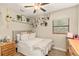 Charming bedroom with natural light, adorned with decorative shelves and comfortable decor at 2929 Lakeshore Dr, Mount Dora, FL 32757