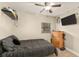 Cozy bedroom featuring a ceiling fan, mounted TV, and natural light at 2929 Lakeshore Dr, Mount Dora, FL 32757