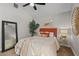 Comfortable bedroom with ceiling fan, stylish decorations, and bright natural light at 2929 Lakeshore Dr, Mount Dora, FL 32757