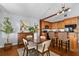Cozy dining area with hardwood floors, seating for four, and direct access to the kitchen at 2929 Lakeshore Dr, Mount Dora, FL 32757