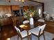 Open-concept dining area with wood floors, modern decor, and seamless flow to the kitchen and living spaces at 2929 Lakeshore Dr, Mount Dora, FL 32757