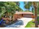 Beautiful home with a well-manicured lawn, outdoor deck, and a convenient two-car garage at 2929 Lakeshore Dr, Mount Dora, FL 32757