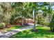 Stunning home with mature trees, a spacious driveway, and lush landscaping at 2929 Lakeshore Dr, Mount Dora, FL 32757