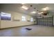 Spacious garage with high ceilings, windows, bright lights, and a clean concrete floor at 2929 Lakeshore Dr, Mount Dora, FL 32757