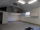 Large two-car garage with overhead lighting and a second-story storage area at 2929 Lakeshore Dr, Mount Dora, FL 32757
