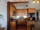 Well-designed kitchen featuring stylish wooden cabinets, granite countertops, and modern black appliances at 2929 Lakeshore Dr, Mount Dora, FL 32757