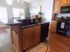 Kitchen island with black countertops and wood cabinets, perfect for cooking and entertaining at 2929 Lakeshore Dr, Mount Dora, FL 32757