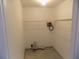 Bright laundry room with simple white walls and a wire shelf ready for customization at 2929 Lakeshore Dr, Mount Dora, FL 32757