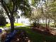Beautiful lawn with mature trees that offer abundant shade and a picturesque lake view at 2929 Lakeshore Dr, Mount Dora, FL 32757