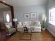 Inviting living room with white sofa, accent chair, and decorative rug, creating a comfortable and stylish space at 2929 Lakeshore Dr, Mount Dora, FL 32757