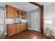 Living area with hardwood floors, built-in wood cabinets, and a decorative white front door at 2929 Lakeshore Dr, Mount Dora, FL 32757