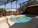 Screened-in pool with tile accents and a view of the fenced backyard at 2929 Lakeshore Dr, Mount Dora, FL 32757
