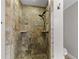 Close-up of the renovated stone shower, with river rock floor and a tiled wall niche at 2929 Lakeshore Dr, Mount Dora, FL 32757