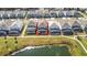Aerial view of a property with a screened pool, situated near a pond, showcasing backyard and neighborhood at 299 Marcello Blvd, Kissimmee, FL 34746