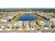 Community aerial view showcasing houses around a lake, with well-maintained streets and lush green spaces at 299 Marcello Blvd, Kissimmee, FL 34746