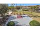 Top-down shot of a private basketball court, surrounded by manicured lawns and palm trees at 299 Marcello Blvd, Kissimmee, FL 34746