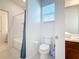 Bathroom featuring a toilet, vanity, and bathtub with tile surround at 299 Marcello Blvd, Kissimmee, FL 34746