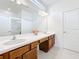 Bathroom showcasing double sinks, a vanity area, and a large mirror with modern lighting at 299 Marcello Blvd, Kissimmee, FL 34746