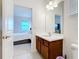 Bathroom sink and mirror are adjacent to the bedroom at 299 Marcello Blvd, Kissimmee, FL 34746