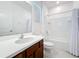 Well-lit bathroom features a modern vanity, tub-shower combo, and tile flooring at 299 Marcello Blvd, Kissimmee, FL 34746