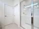 Bright bathroom with a glass-enclosed shower featuring tile surround and chrome fixtures at 299 Marcello Blvd, Kissimmee, FL 34746