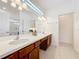Elegant bathroom with double sinks, vanity lighting, and a large mirror, providing a spa-like experience at 299 Marcello Blvd, Kissimmee, FL 34746