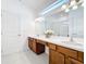 Stylish bathroom featuring dual sinks, ample counter space, and modern lighting for added convenience at 299 Marcello Blvd, Kissimmee, FL 34746