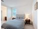 Bedroom with gray headboard, two side tables, and gray carpet at 299 Marcello Blvd, Kissimmee, FL 34746