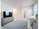 Bedroom with gray dresser, TV, and light-filled window at 299 Marcello Blvd, Kissimmee, FL 34746