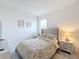 Bedroom with a plush bed, bedside tables with lamps, a window with blinds, and decor at 299 Marcello Blvd, Kissimmee, FL 34746