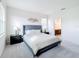 Bright bedroom features a cozy bed, soft carpet, and stylish decor, creating a relaxing retreat at 299 Marcello Blvd, Kissimmee, FL 34746
