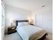 Bedroom with a cozy bed, nightstands with lamps, and plush carpeting at 299 Marcello Blvd, Kissimmee, FL 34746