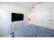 Bright bedroom featuring modern furniture, a sleek TV stand, plush carpeting, and freshly painted white walls at 299 Marcello Blvd, Kissimmee, FL 34746