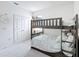 Neutral bedroom featuring a bunk bed with stairs and coastal decor, with a carpeted floor and white walls at 299 Marcello Blvd, Kissimmee, FL 34746