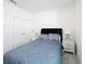Bright bedroom features a soft bed with nightstands, complemented by plush carpeting, and freshly painted white walls at 299 Marcello Blvd, Kissimmee, FL 34746