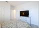 Bedroom with a large television atop a dresser, a plush bed, and neutral carpeting at 299 Marcello Blvd, Kissimmee, FL 34746