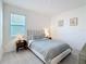 Bedroom with gray headboard, two side tables, and gray carpet at 299 Marcello Blvd, Kissimmee, FL 34746