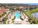 Aerial view of a stunning community pool, surrounded by lounge chairs and lush landscaping at 299 Marcello Blvd, Kissimmee, FL 34746